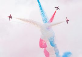 Red arrows perform a colorful aerial display.