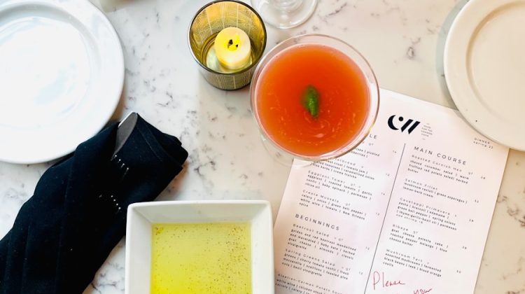 Cocktails, bread, and menu items displayed on a table.