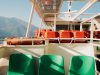 On a boat with seats and life preservers.